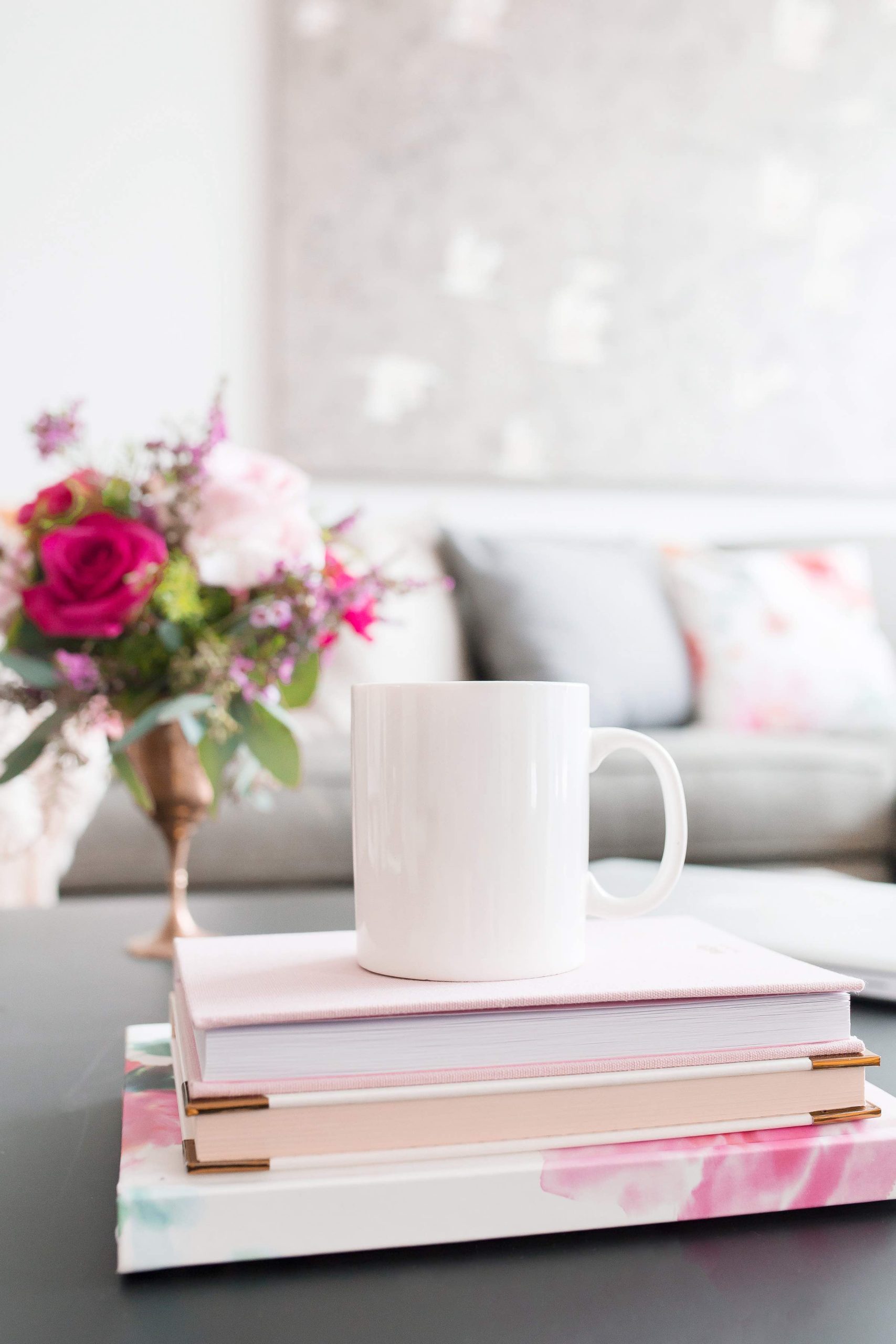 white mug on stack of books on coffee table